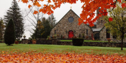Exterior of St. Joseph Abbey church in fall