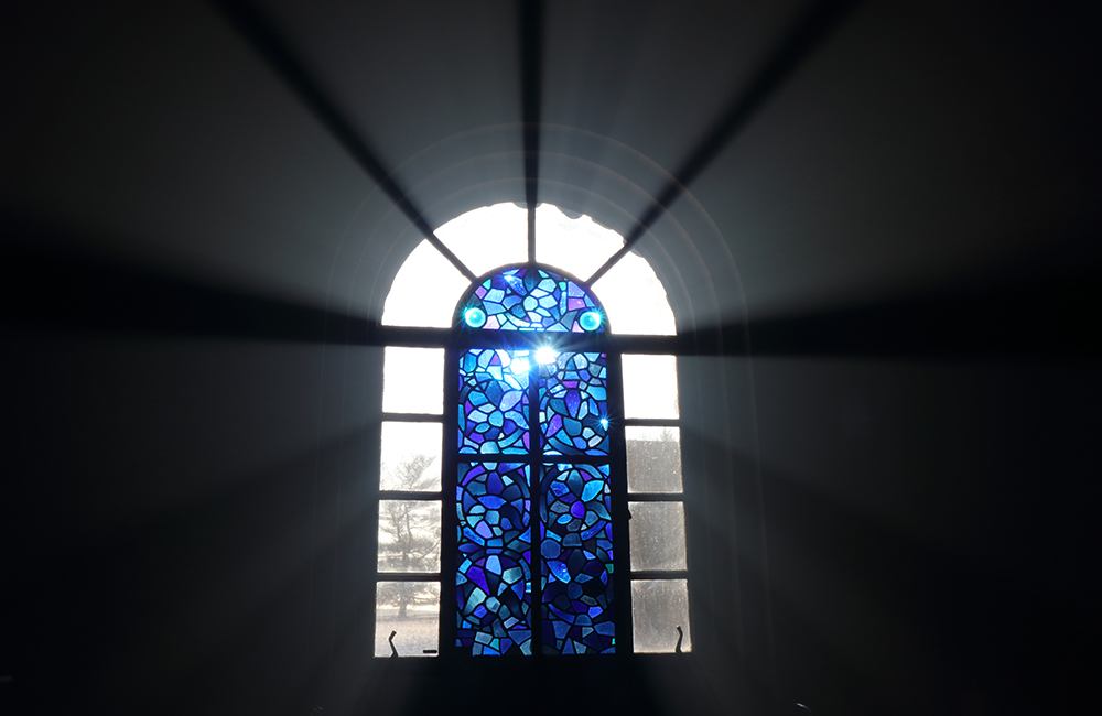 stained glass window with light streaming through