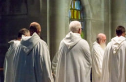 men in robes at prayer