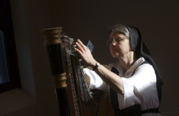 Nun playing harp