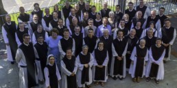A birds eye view of Cistercian monks and nuns pose for a picture