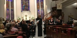 Father Joseph Tedesco speaking in Luthern church at Una Sancta concedrt