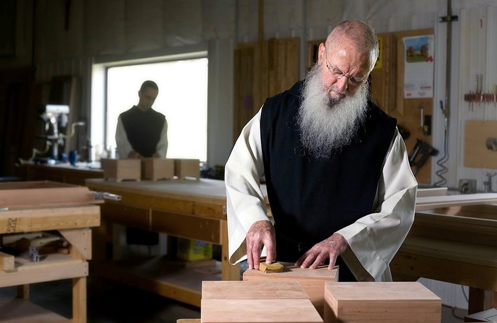 Monks working with wood blocks in carpenter shop