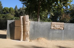 blocks of ancient stone inlayed into concrete wall