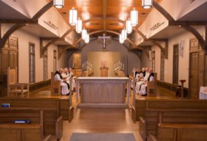 Monks at Mass sitting around the altar