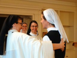 Nuns welcome one another with smiles.