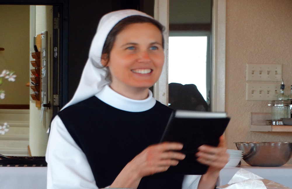 Sr. Madeline's first profession, smiling and holding a book