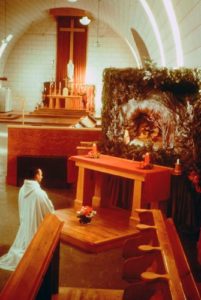 Monk praying before nativity scene in Trinity Abbey Church, Huntsville Utah
