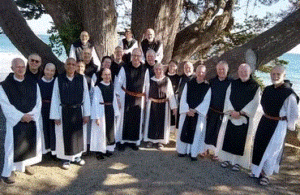 US Superiors pose in front of a large tree at Regional Superiors meeting