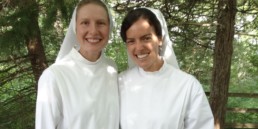 2 New Novices at Mississippi Abbey smile in white habits