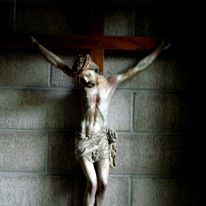 Realistic crucifix hanging on mason block wall at New Clairvaux Abbey