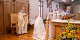 Br. Mary John Blaschik kneels in front of Abbot Joseph at Holy Cross Abbey