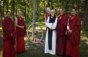 Buddhist monks pose with a Trappist monk at Gethsemani Abbey