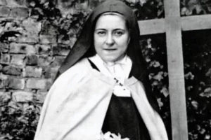 Black and White photo of St. Therese with a cross in the background