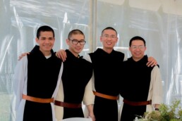 4 Trappist brother monks smiling